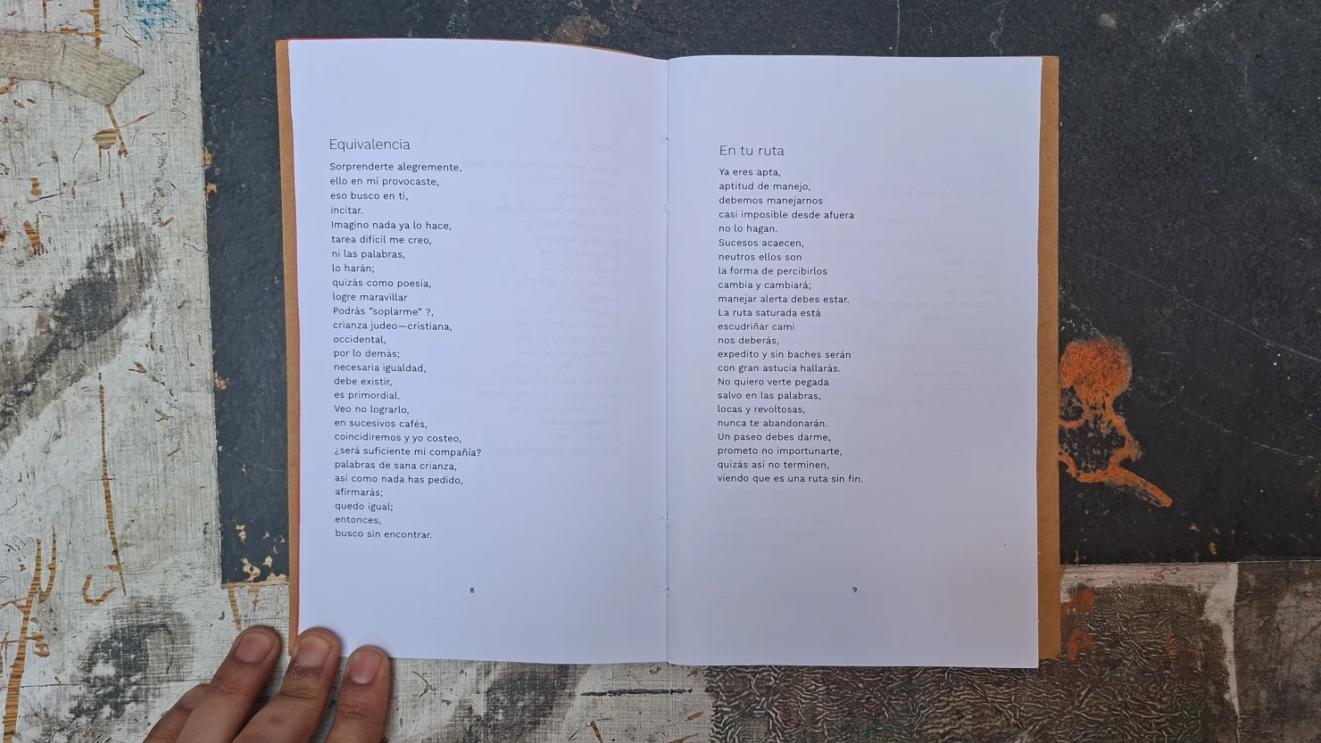Open book at two poems, &ldquo;Equivalencia&rdquo; and &ldquo;En tu ruta&rdquo;