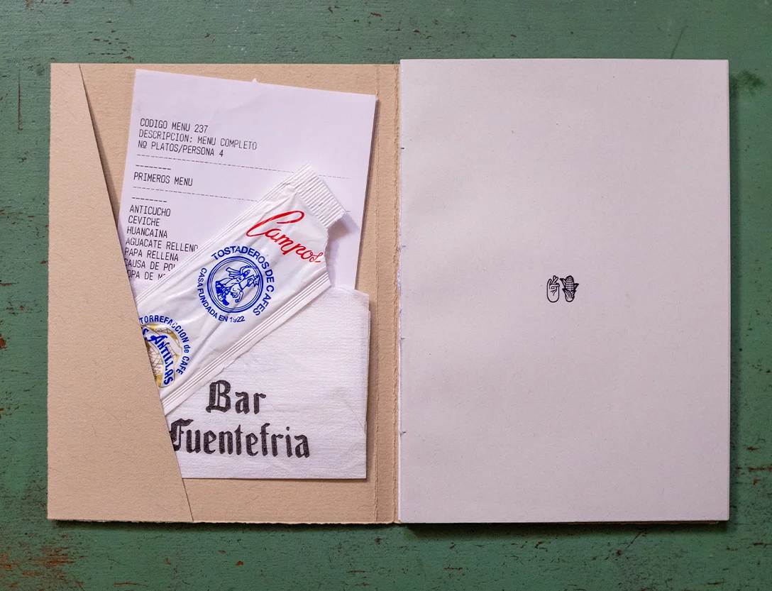 Inside cover with a pocket holding a menu, a coffee sachet and a napkin
