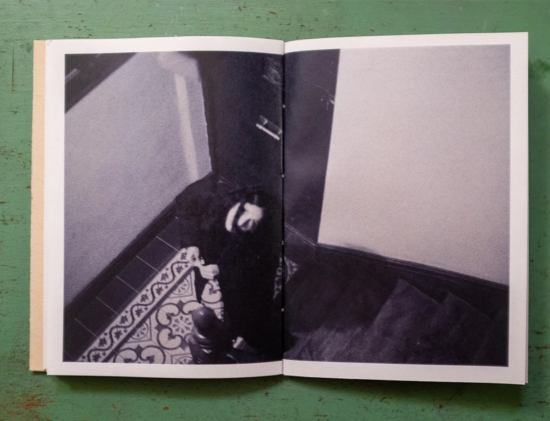Black and white photo spread of a figure on a tiled staircase