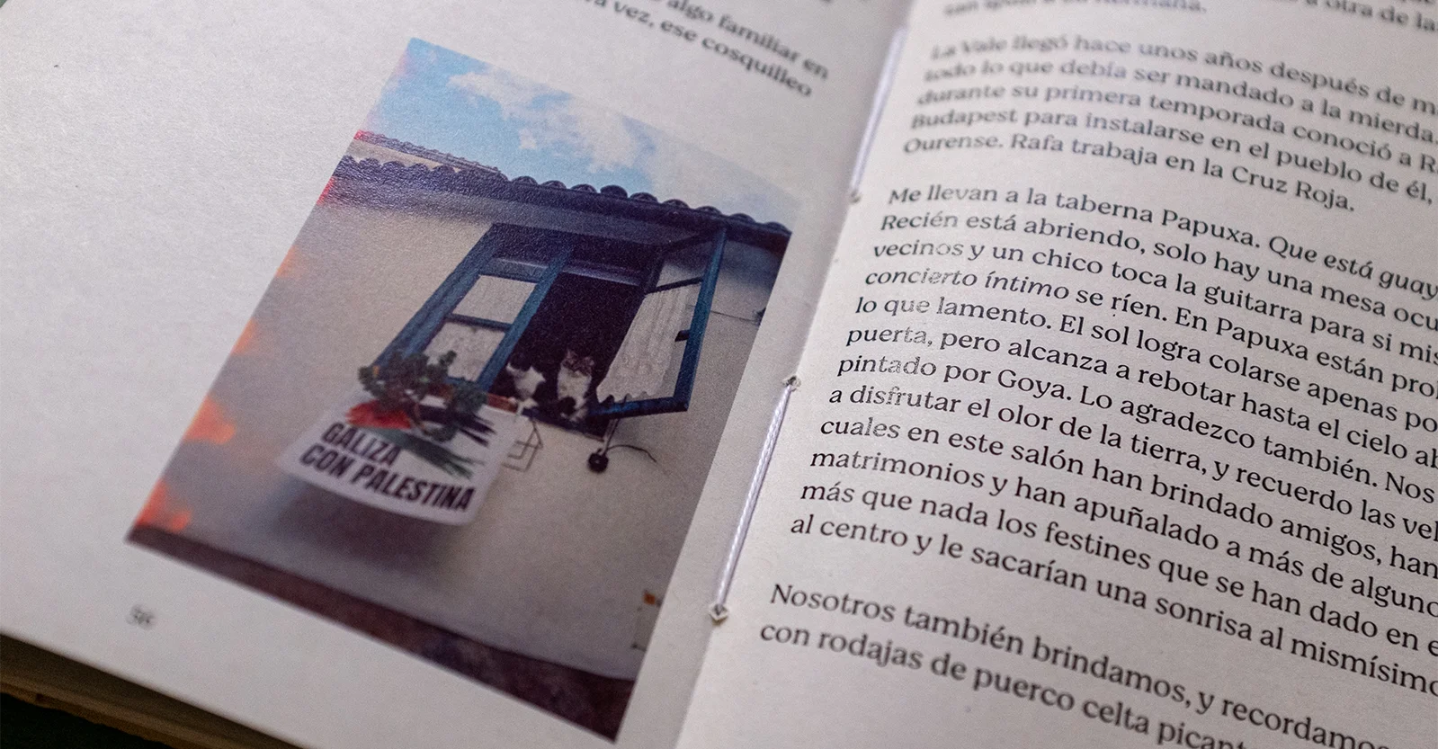 Close-up of a text spread with a photo of a window with a banner