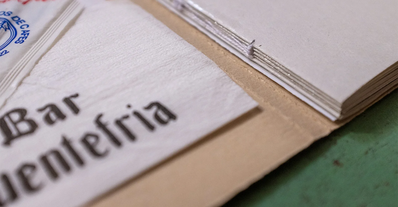 Close-up of a napkin and the stitched spine of the book